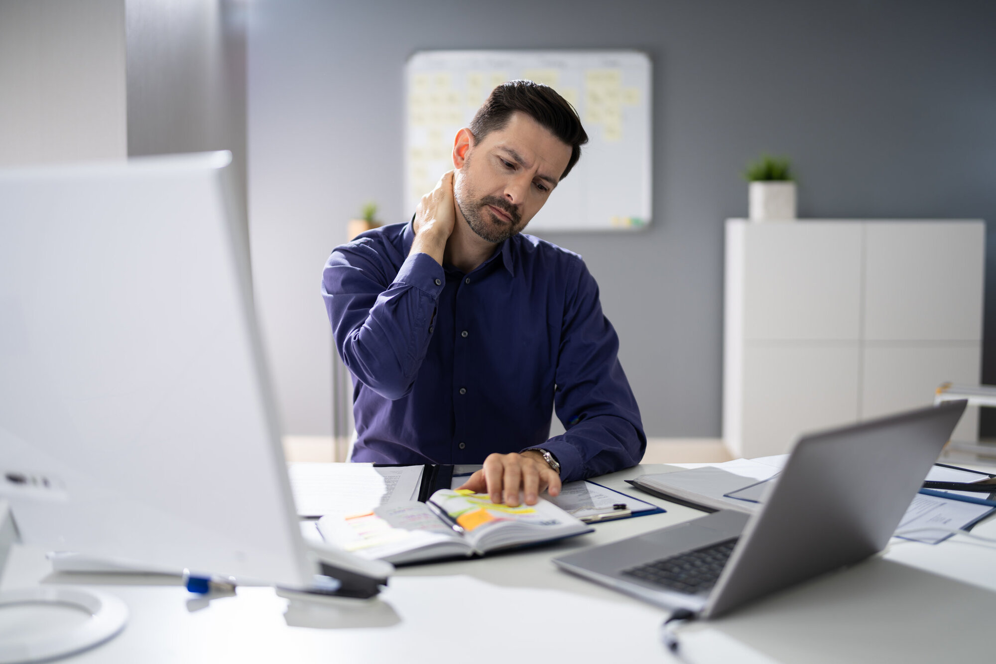 Businessman with neck pain from computer Businessman with neck pain from computer