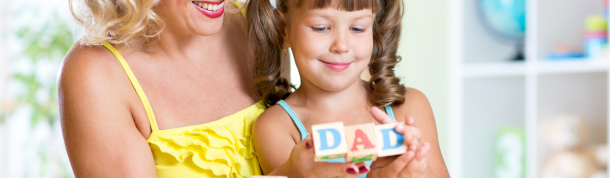 Girl learning how to write using letter blocks