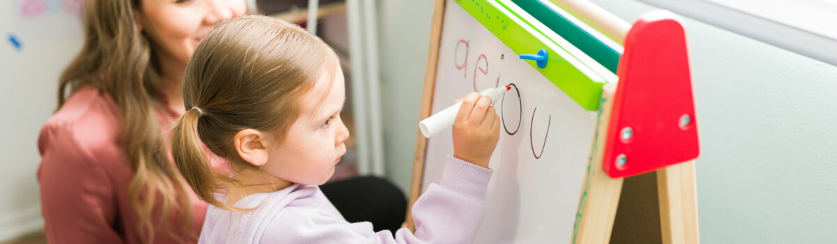 Girl with dyslexia writing bubble letters