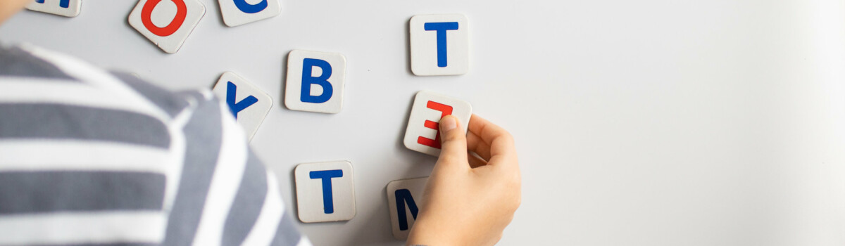 Child with dyslexia using magnetic letters