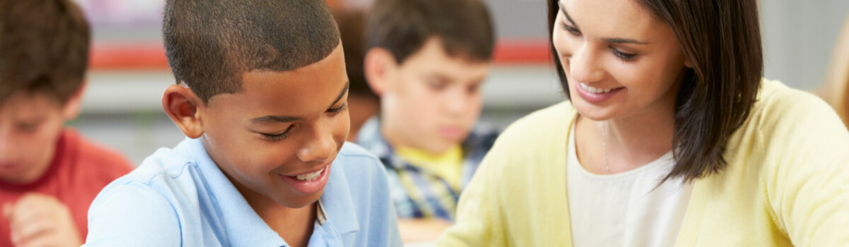 Key person helping a young boy with his work