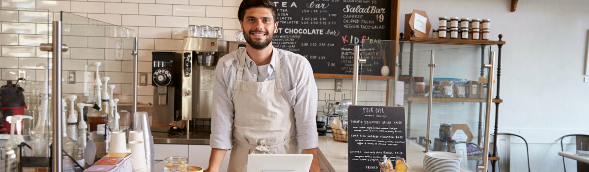 Coffee shop worker at till