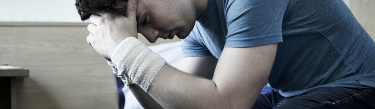 Man showing indications of self harm due to multiple mental illnesses