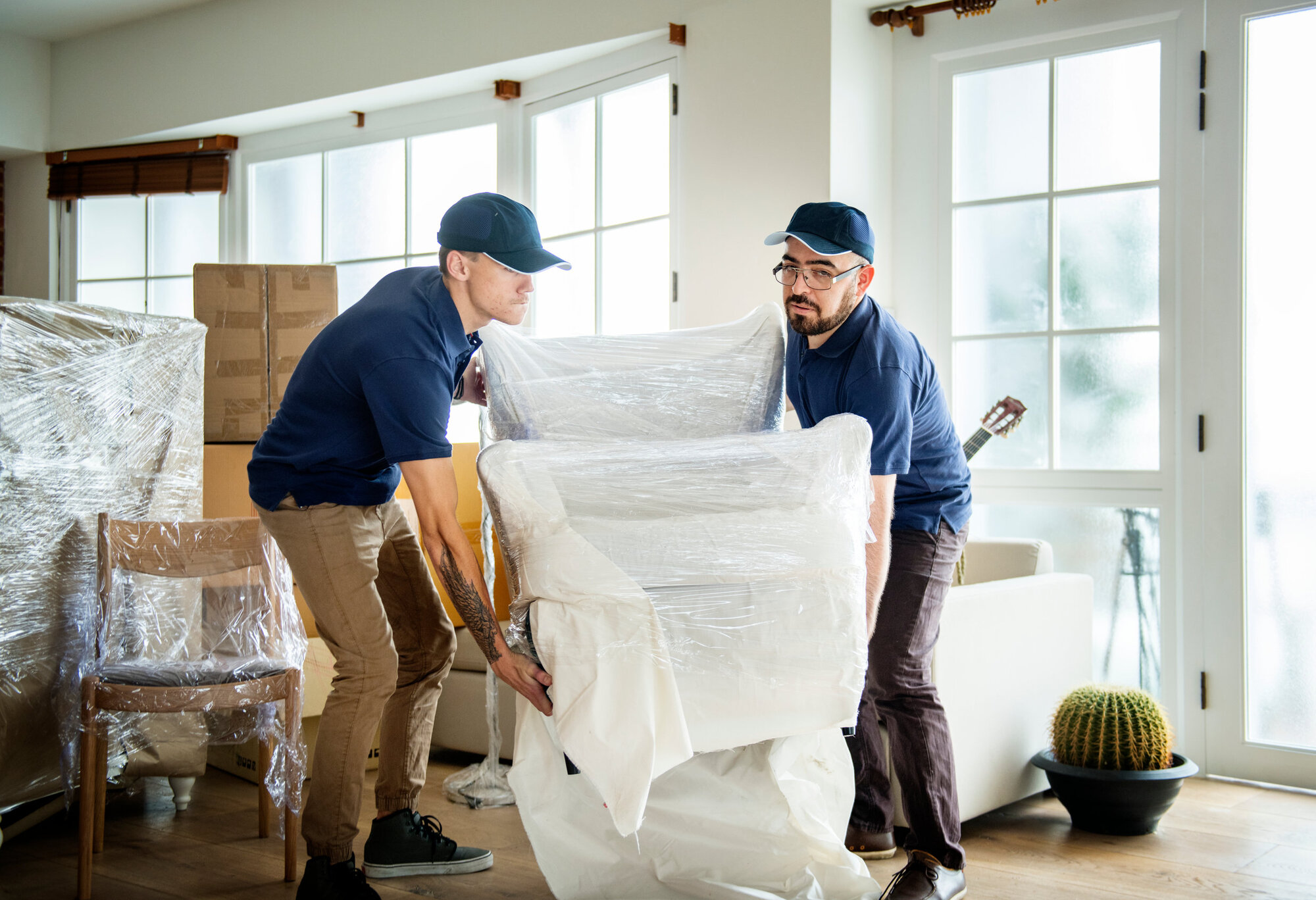 Delivery men carrying heavy objects Delivery men carrying heavy objects