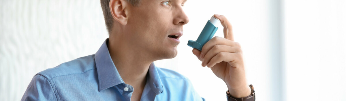 Man struggling with asthma due to hay fever