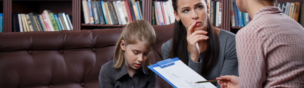 Parent discussing child's medication with teacher