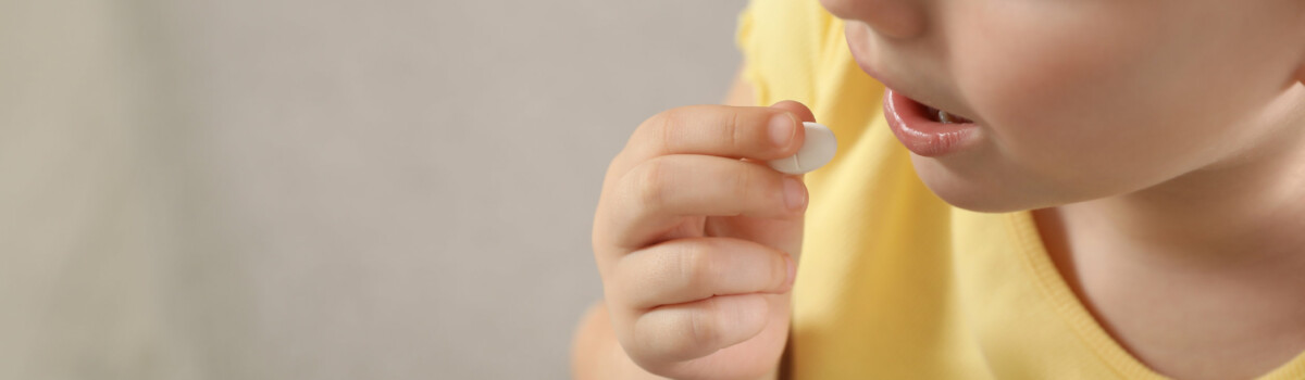 Young girl being given medication in school