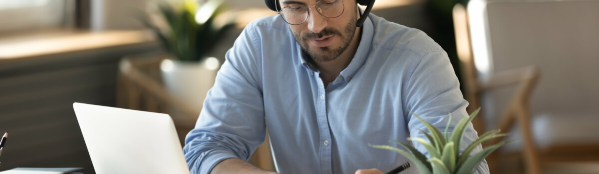 Man taking meeting minutes over video conference