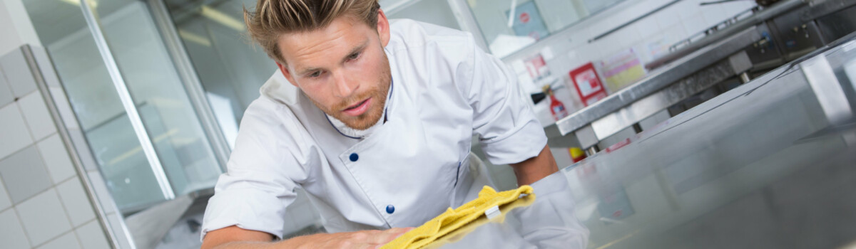 A chef cleaning a kitchen