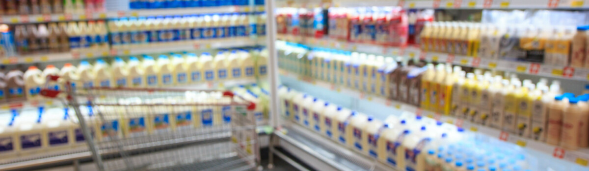 Fresh dairy products on display in supermarket after being checked for best before date