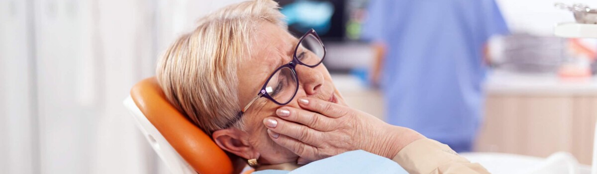 Older woman suffering from dental pain