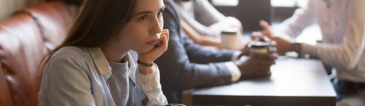 Woman with social anxiety in café