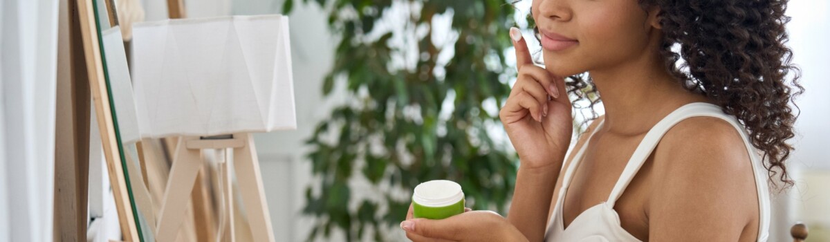 Woman using skin bleaching cream