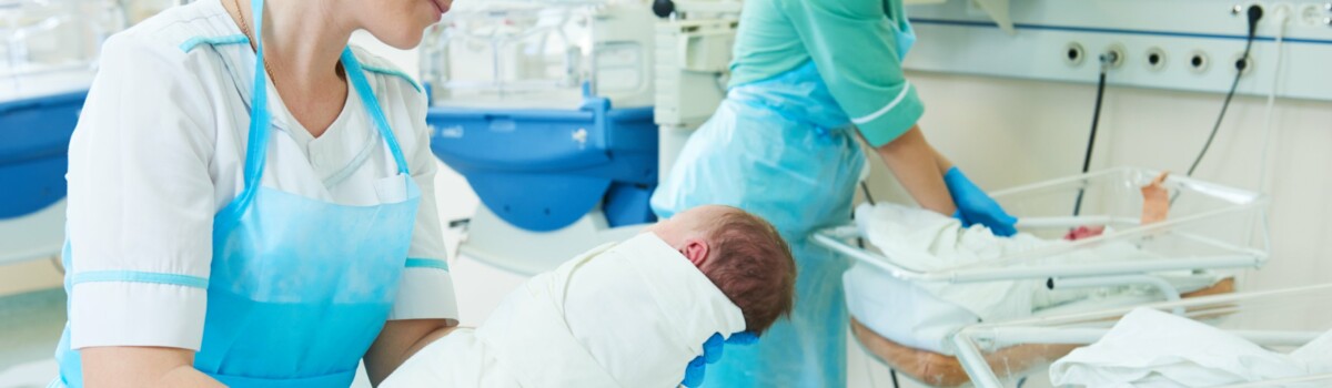 Nurses demonstrating caring for new-born baby