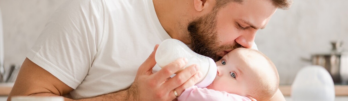 Infant being fed from sterilised bottle