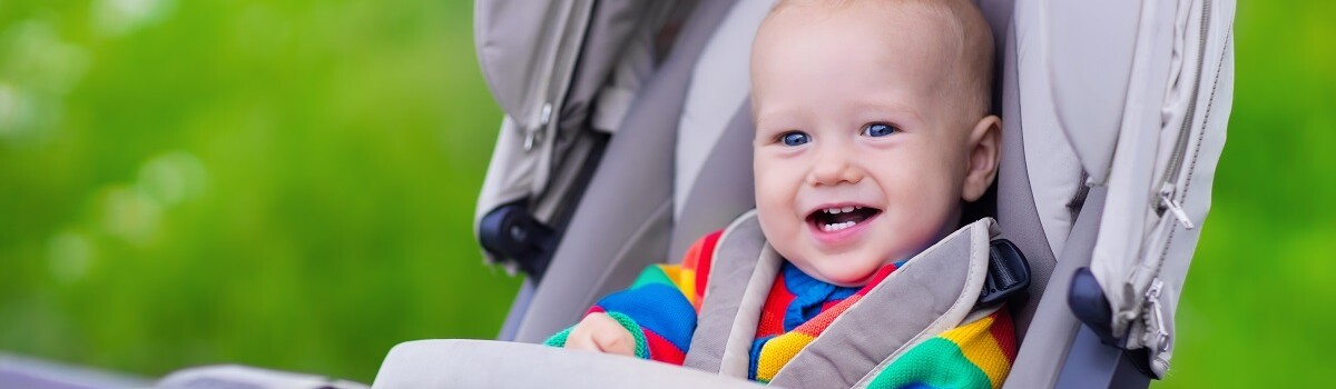 Infant securely strapped in pushchair